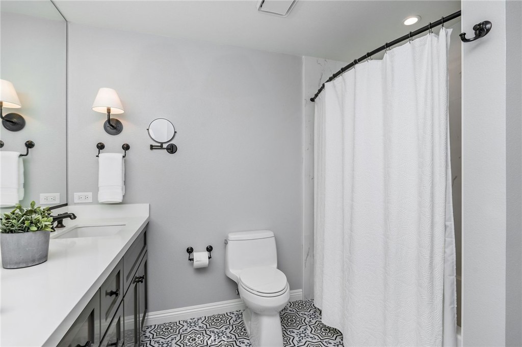 30392 North Hampton Road Laguna Niguel, CA 92677 - Photo 33 of 44 a bathroom with a sink a toilet and a mirror