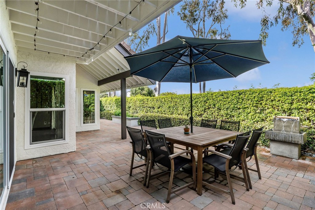 30392 North Hampton Road Laguna Niguel, CA 92677 - Photo 40 of 44 a view of an outdoor dining space with furniture and umbrella