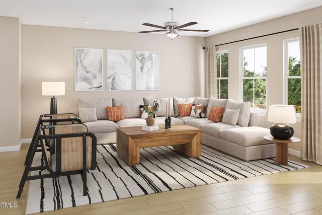 a living room with furniture a fireplace and a large window