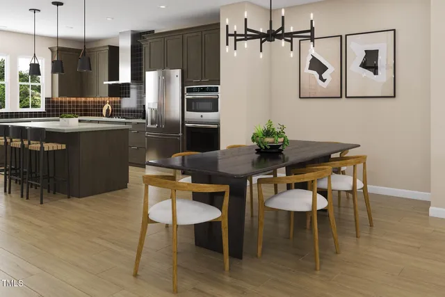 a kitchen with stainless steel appliances granite countertop a sink a stove a refrigerator and island