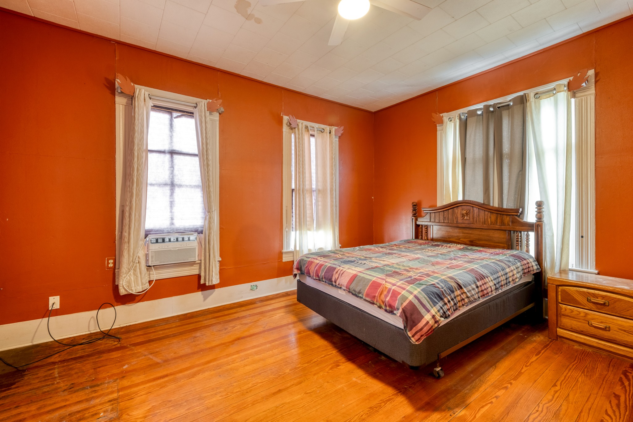 300 South Rio Grande Street Granger, TX 76530 - Photo 15 of 25 Bedroom featuring wood finished floors, ceiling fan, and cooling unit