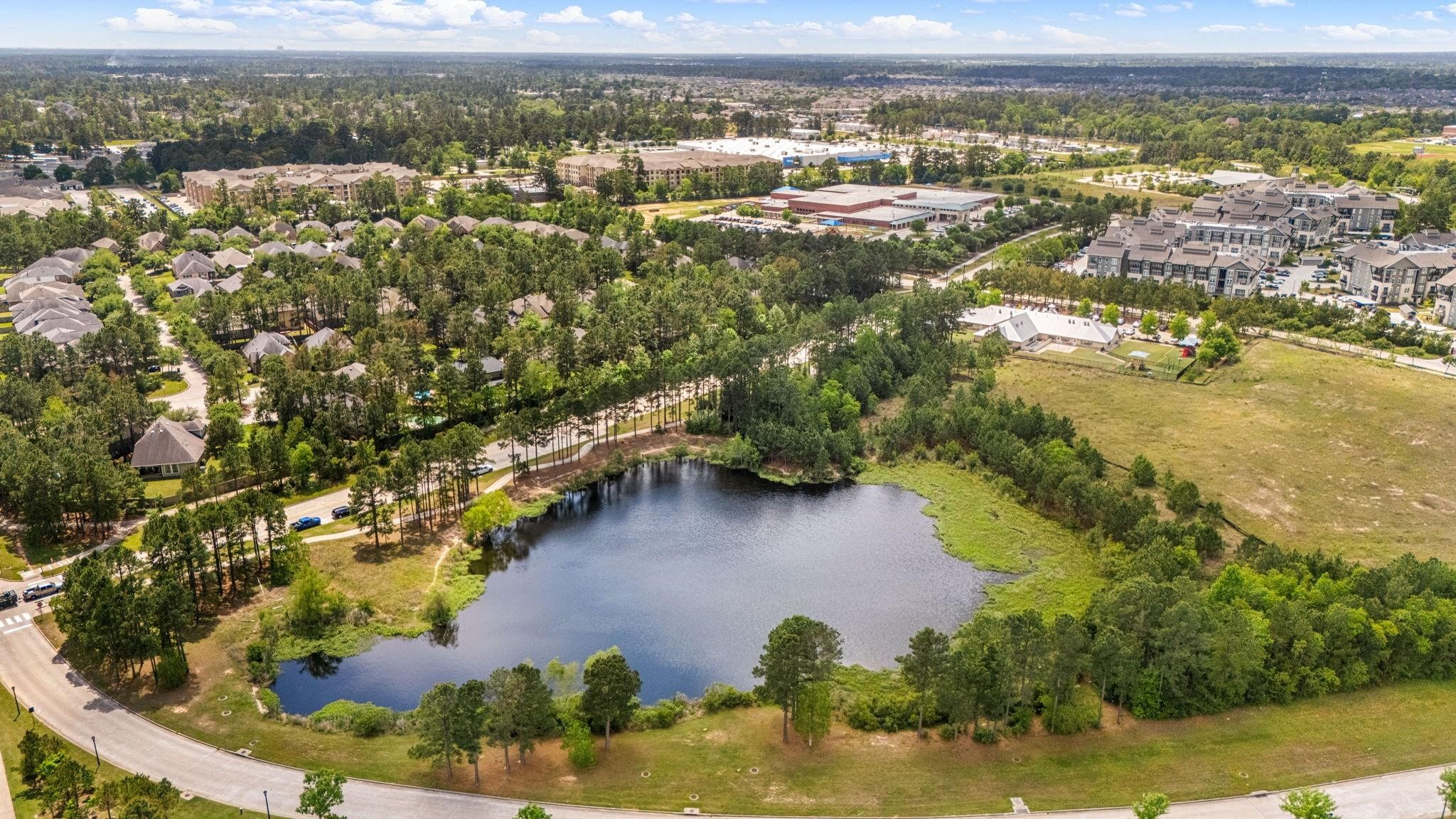 98 Herons Flight Place Spring, TX 77389 - Photo 26 of 29 This stunning aerial view showcases the unparalleled lifestyle of Creekside Park in The Woodlands. Surrounded by lush greenery and serene community lakes, this residence is perfectly positioned just moments from world-class amenities.