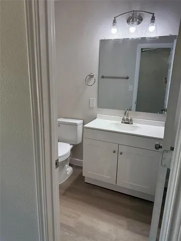 a bathroom with a sink toilet and mirror
