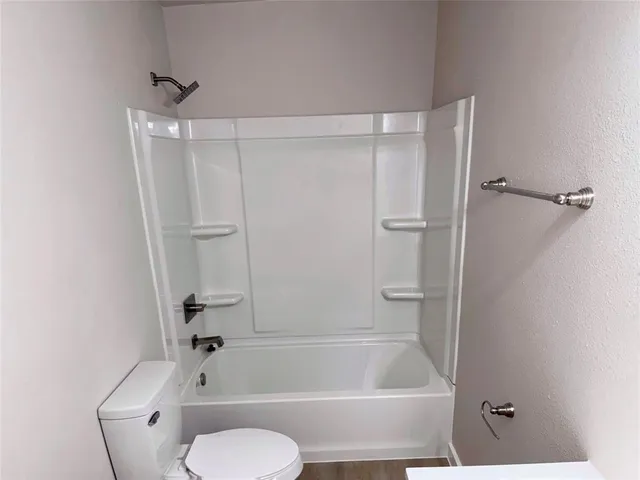 a bathroom with a toilet and a bathtub