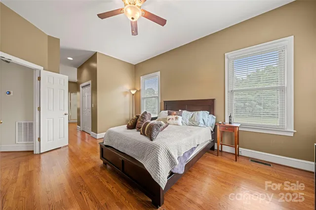 a living room with furniture kitchen view and a wooden floor