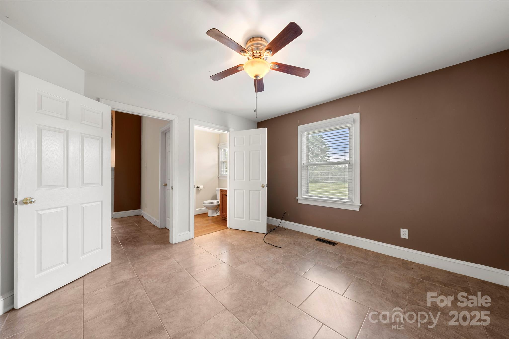 6218 Indian Trail Fairview Road Indian Trail, NC 28079 - Photo 22 of 46 a view of an empty room with a ceiling fan and window
