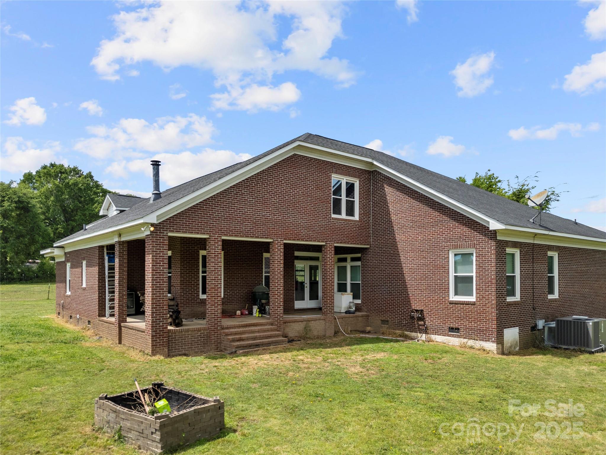6218 Indian Trail Fairview Road Indian Trail, NC 28079 - Photo 37 of 46 a view of a house with a patio and a yard