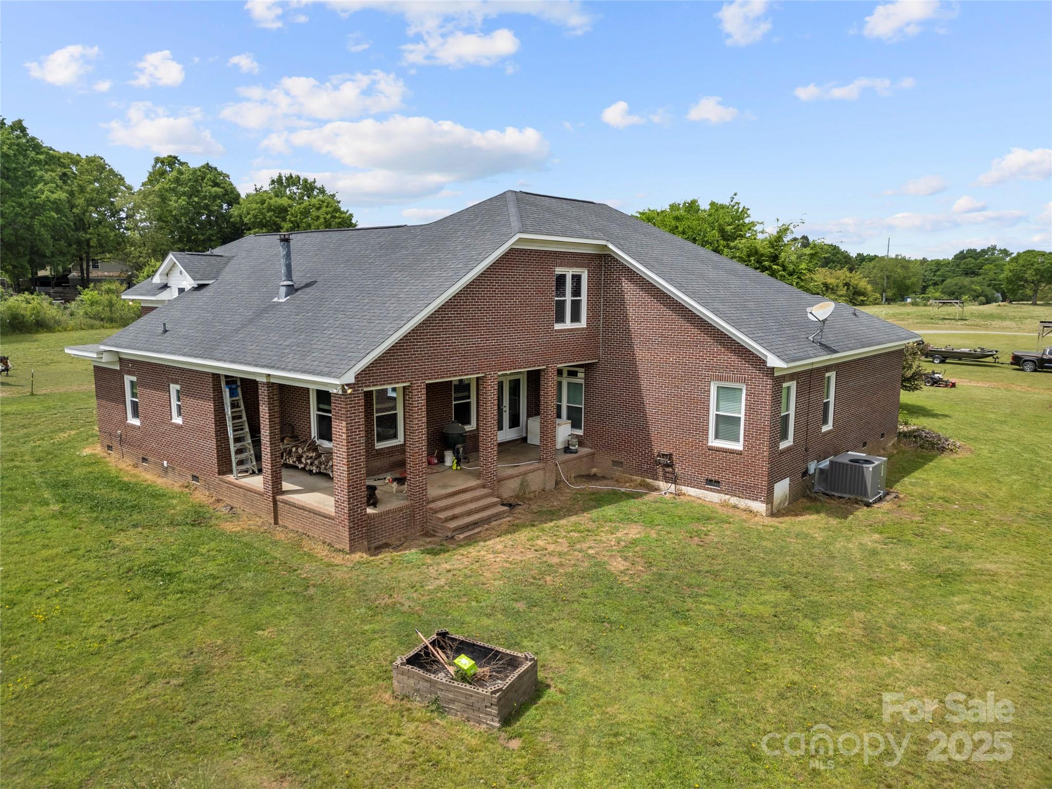 6218 Indian Trail Fairview Road Indian Trail, NC 28079 - Photo 41 of 46 a aerial view of a house with swimming pool and a yard