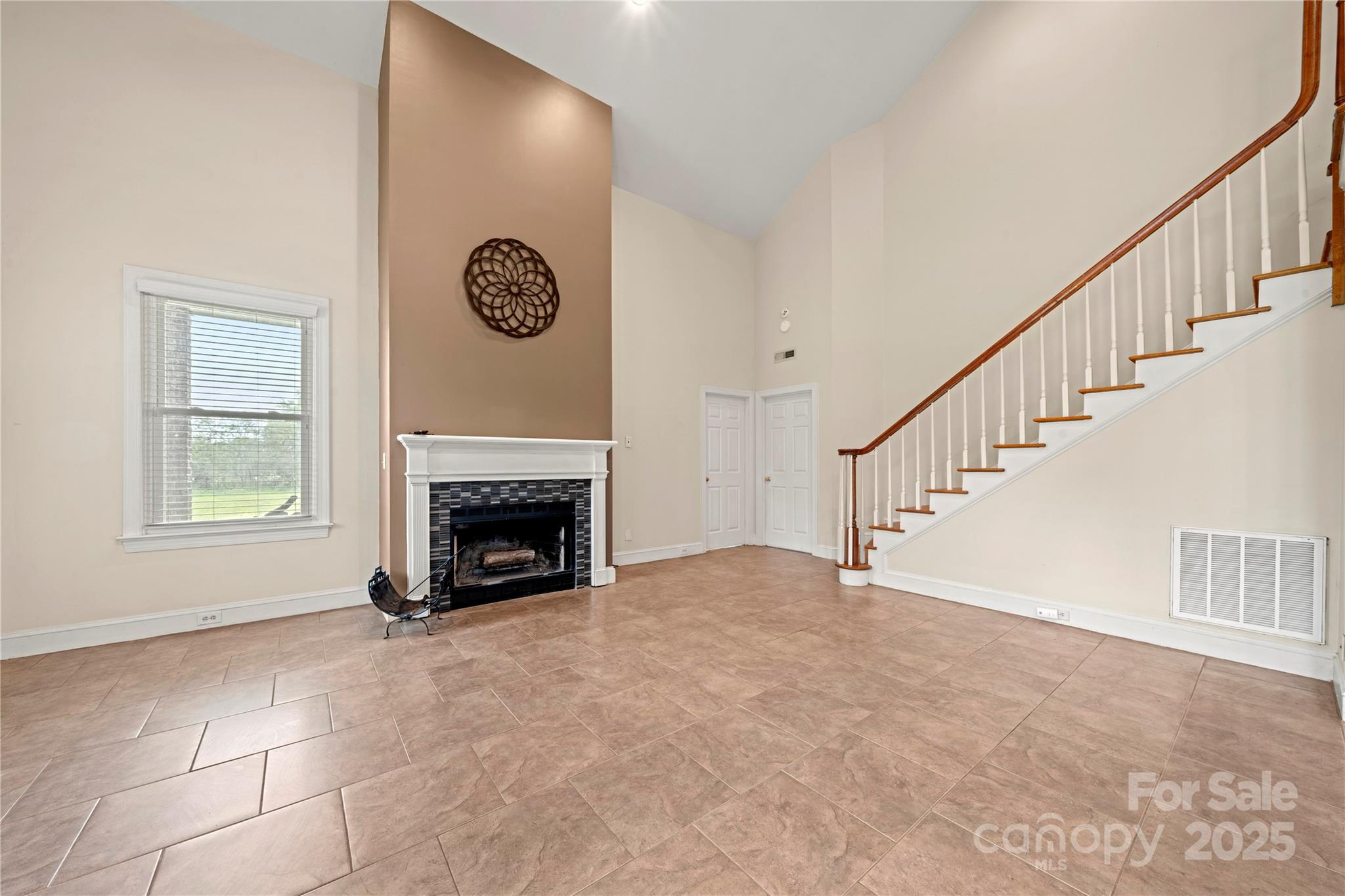 6218 Indian Trail Fairview Road Indian Trail, NC 28079 - Photo 7 of 46 a view of an empty room with a fireplace and a window