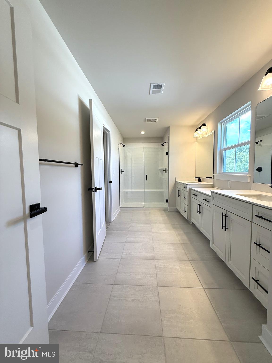 14566 Workman Circle Milton, DE 19968 - Photo 11 of 15 a large white kitchen with a sink and refrigerator