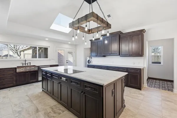 a kitchen with stainless steel appliances granite countertop a sink a stove and a refrigerator
