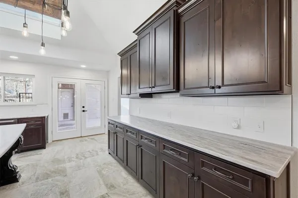 a kitchen with stainless steel appliances granite countertop a sink a stove and a refrigerator