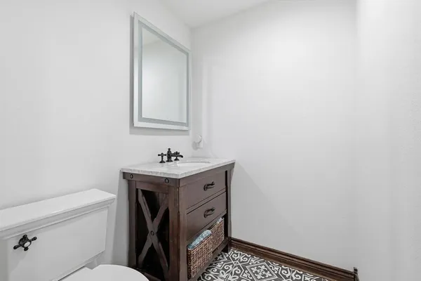 a large kitchen with stainless steel appliances a large counter top a wooden floor and window