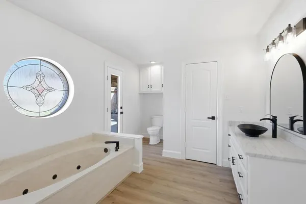 a bathroom with a tub and a window