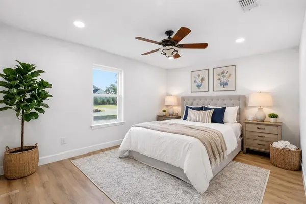 a spacious bathroom with a tub sink and mirror