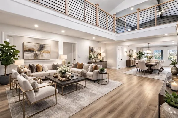 a view of a livingroom with wooden floor and stairs