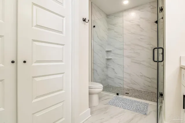 a bathroom with a shower and a toilet
