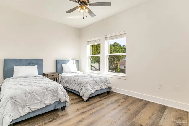 a bedroom with two bed and a view of bedroom