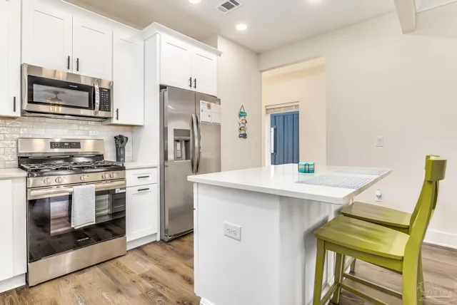 a kitchen with stainless steel appliances a refrigerator sink and cabinets