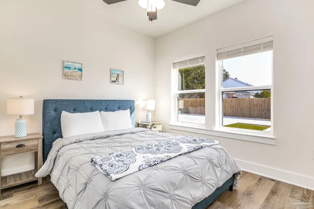 a bedroom with a bed and a wooden floor