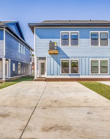 a view of a house with a small yard