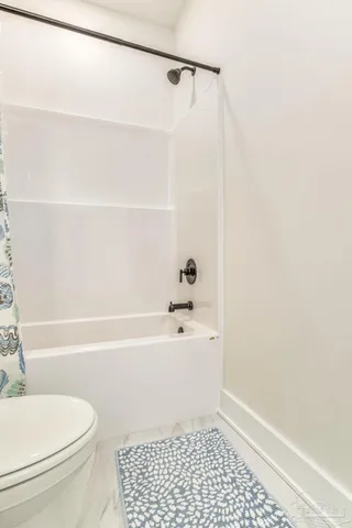 a bathroom with a bathtub and a toilet