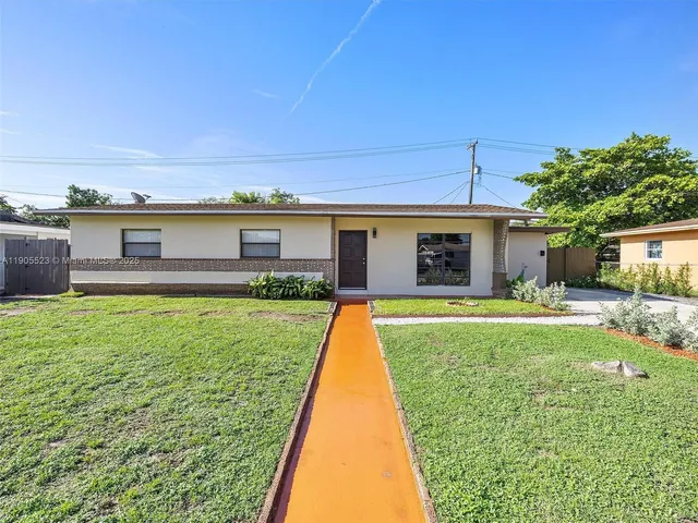 a view of a house with a yard patio and a patio
