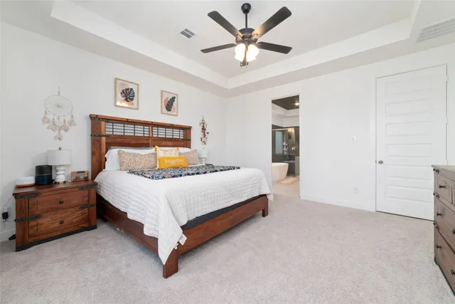 a spacious bathroom with a double vanity sink mirror and bathtub