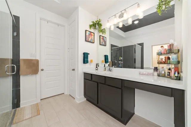 a bathroom with a tub a sink and a mirror