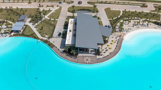 an aerial view of a swimming pool with outdoor seating