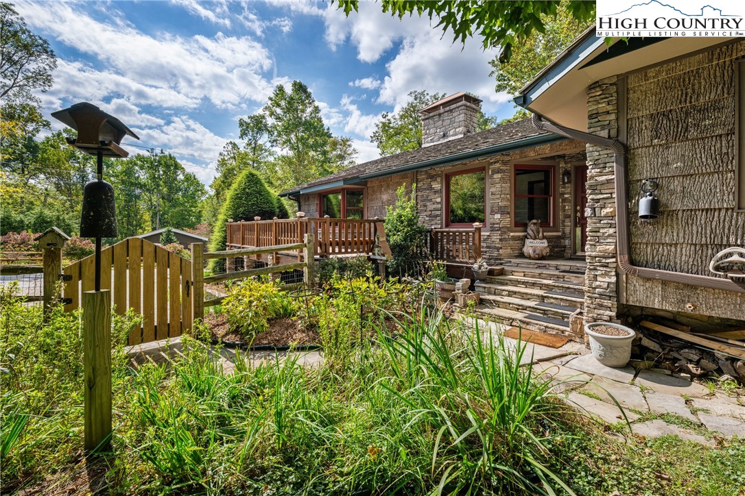 a view of a chair and tables in the patio in front of a house