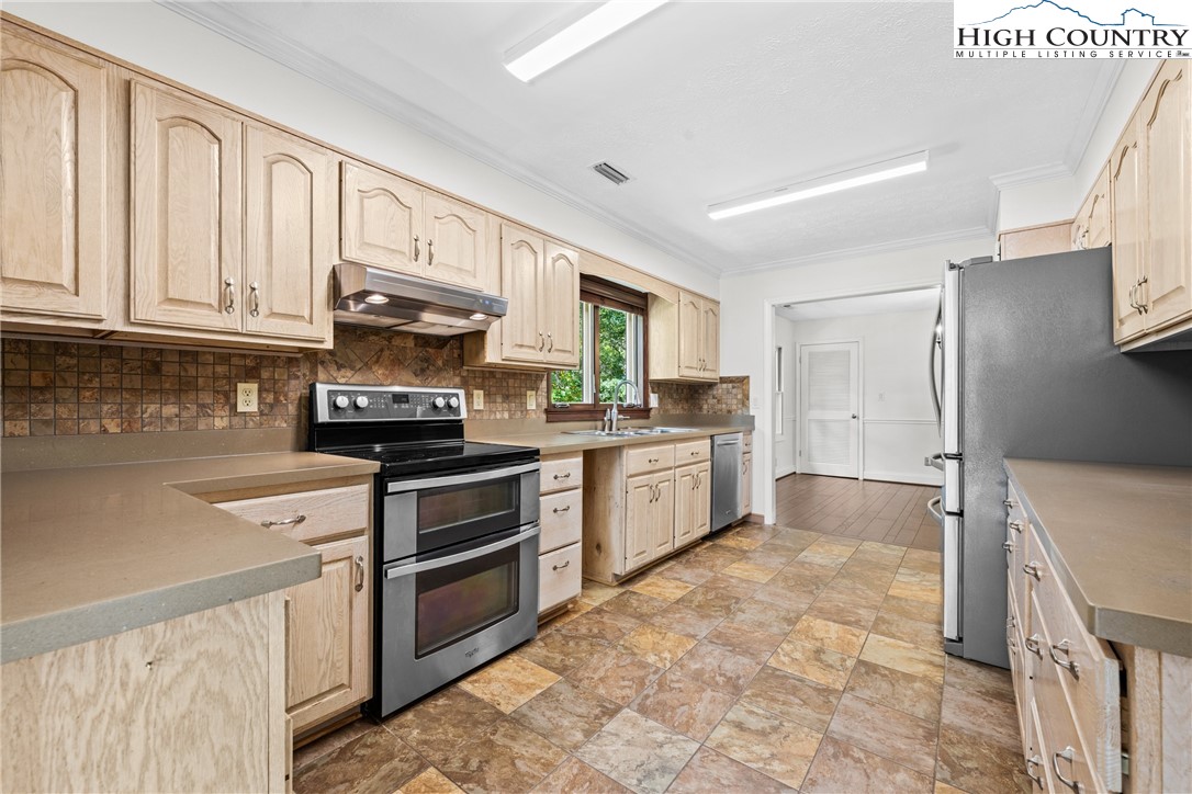 955 Dogwood Boone, NC 28607 - Photo 11 of 48 a kitchen with stainless steel appliances granite countertop a stove a sink and a refrigerator