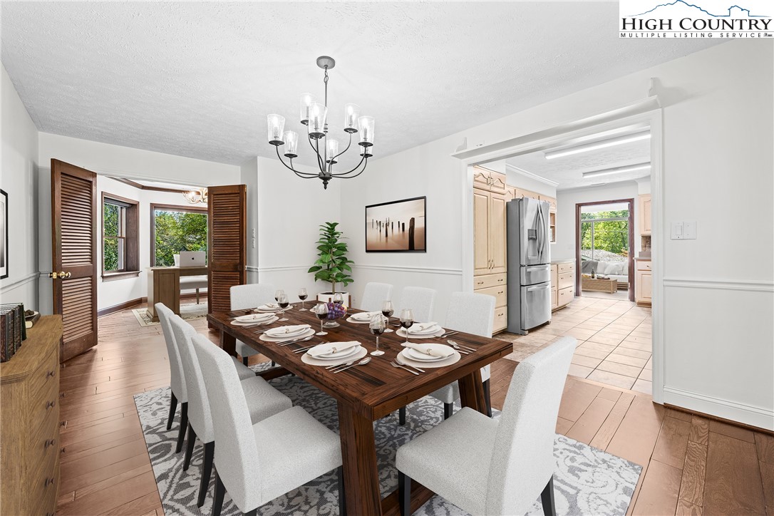 955 Dogwood Boone, NC 28607 - Photo 13 of 48 a view of a dining room with furniture wooden floor and chandelier