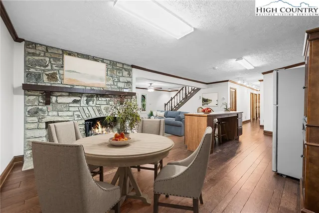 a dining room with furniture and wooden floor