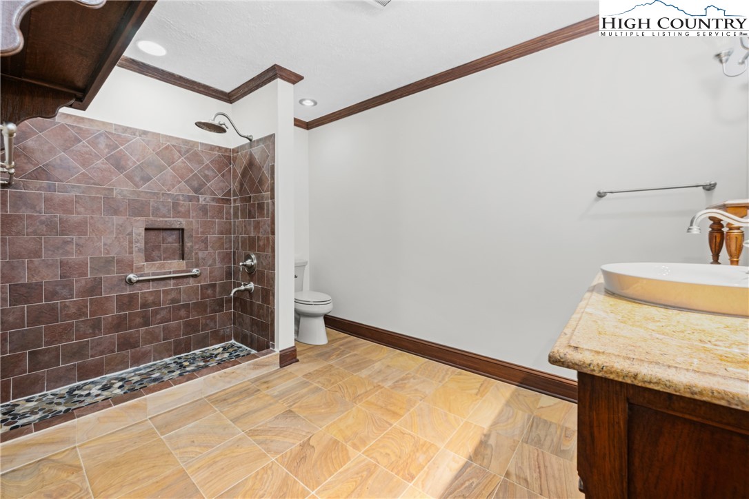 955 Dogwood Boone, NC 28607 - Photo 30 of 48 a bathroom with a granite countertop sink and shower
