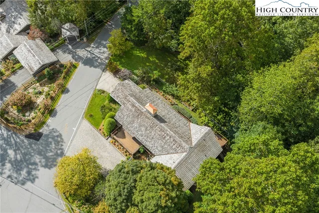 an aerial view of a house with a yard