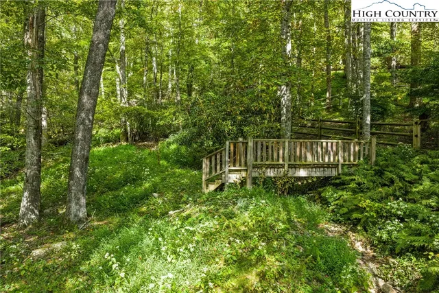 a backyard of a house with lots of green space and garden