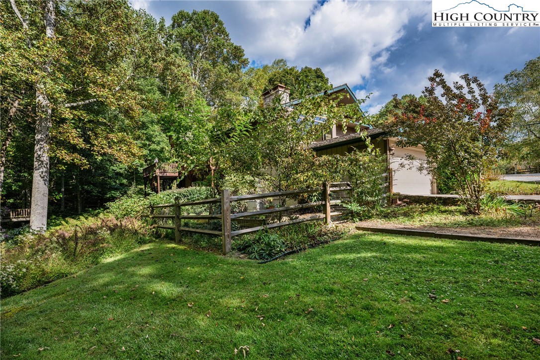 955 Dogwood Boone, NC 28607 - Photo 47 of 48 a backyard of a house with lots of green space and garden