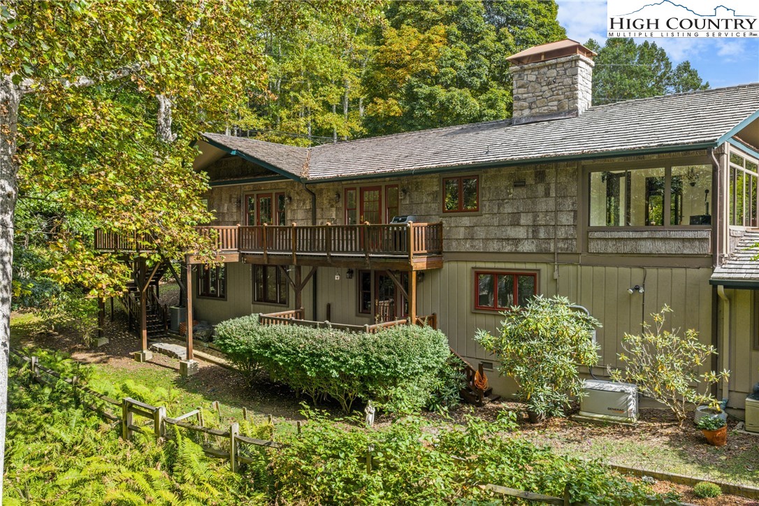 955 Dogwood Boone, NC 28607 - Photo 5 of 48 a view of a house with brick walls plants and large tree