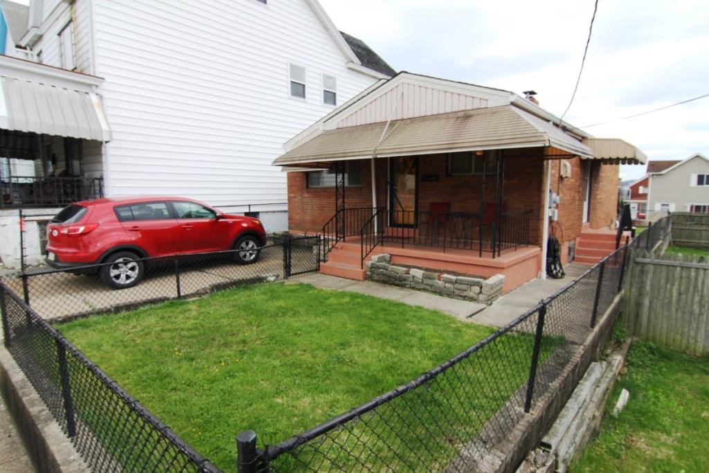 75 McKinnie Avenue McKees Rocks, PA 15136 - Photo 3 of 19 3)Exterior Front: Very usable level lot with fully fenced front & back yards for pets and children.