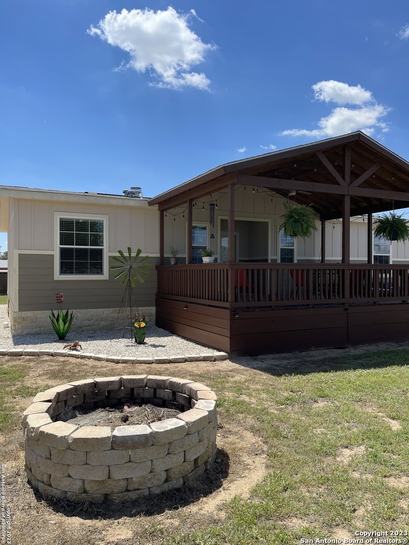 a view of a house with backyard swimming pool and sitting area