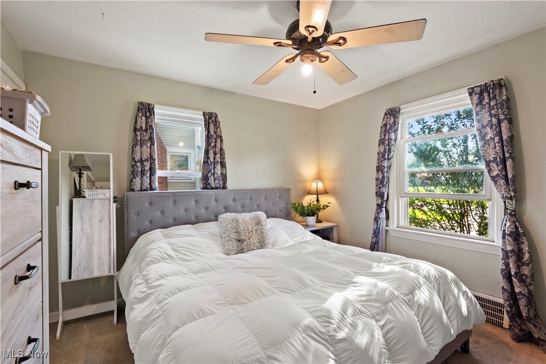 1271 Lander Road Cleveland, OH 44124 - Photo 11 of 37 Retreat to your primary bedroom, where cozy carpeting and graceful draperies create a warm and restful ambiance.