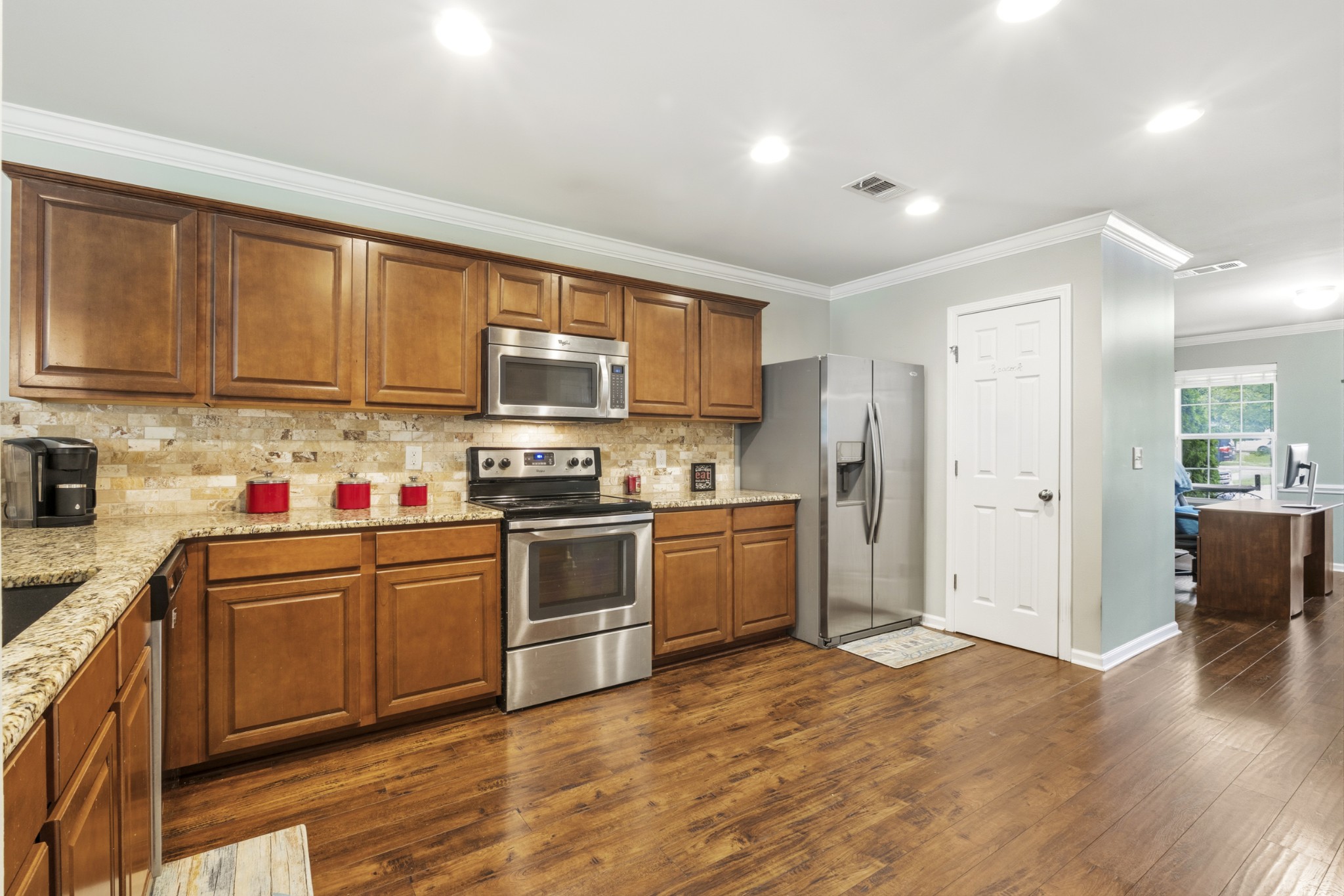 1011 Benwick Road Hendersonville, TN 37075 - Photo 14 of 60 a kitchen with stainless steel appliances granite countertop a refrigerator stove top oven and sink with wooden floor