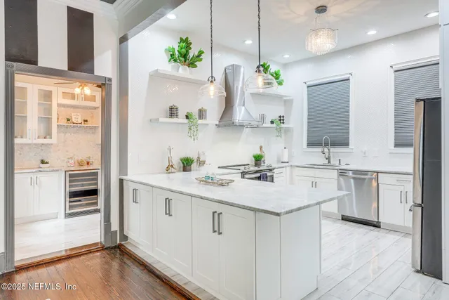 a kitchen with white cabinets stove and refrigerator