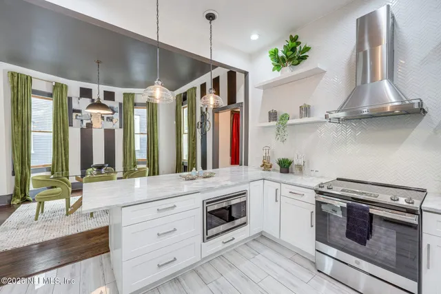 a kitchen with stainless steel appliances a stove and a refrigerator