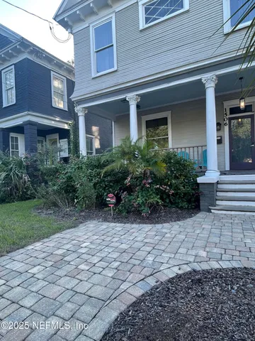 a view of a brick building next to a yard