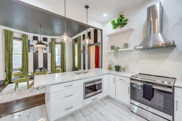 a kitchen with stainless steel appliances a stove and a refrigerator
