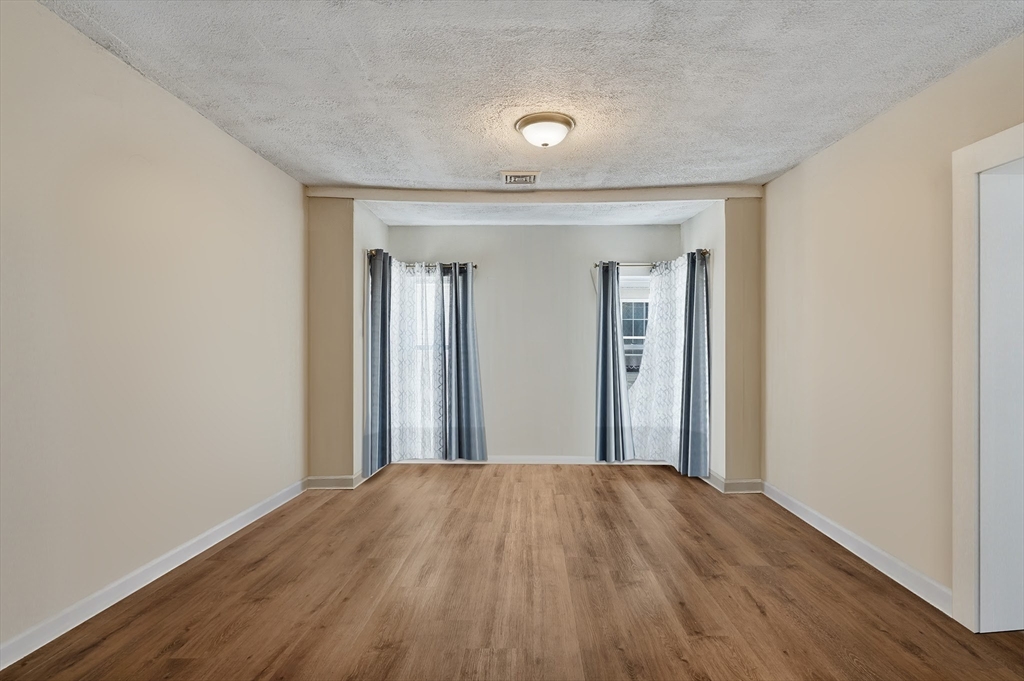 196 Irving Street Fall River, MA 02723 - Photo 30 of 34 a view of a room with wooden floor and a bathroom