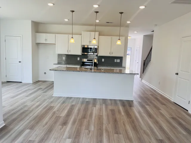 a large kitchen with stainless steel appliances kitchen island a large island in the center