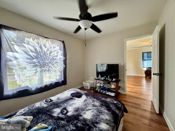 a bedroom with a bed and wooden floor